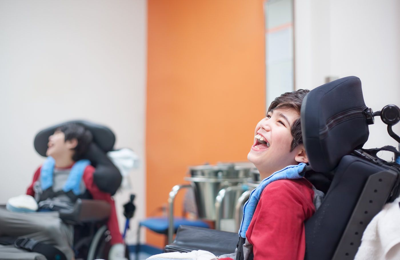 A caregiver and client laughing together over a game of chess